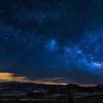 black mountains under the stars at nighttime